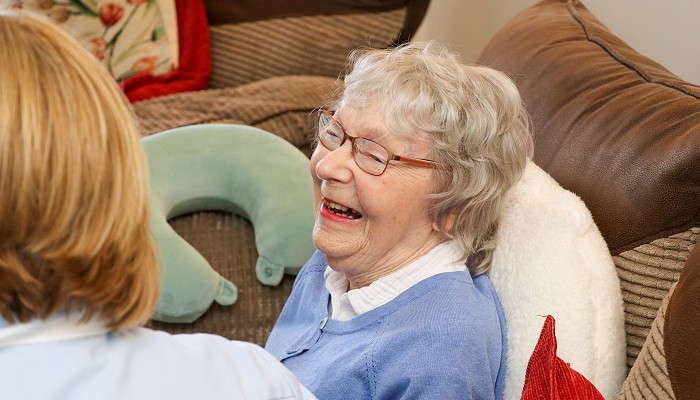 woman in an armchair laughing