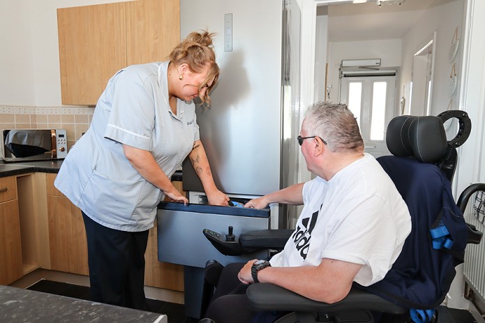 carer and client looking in the freezer